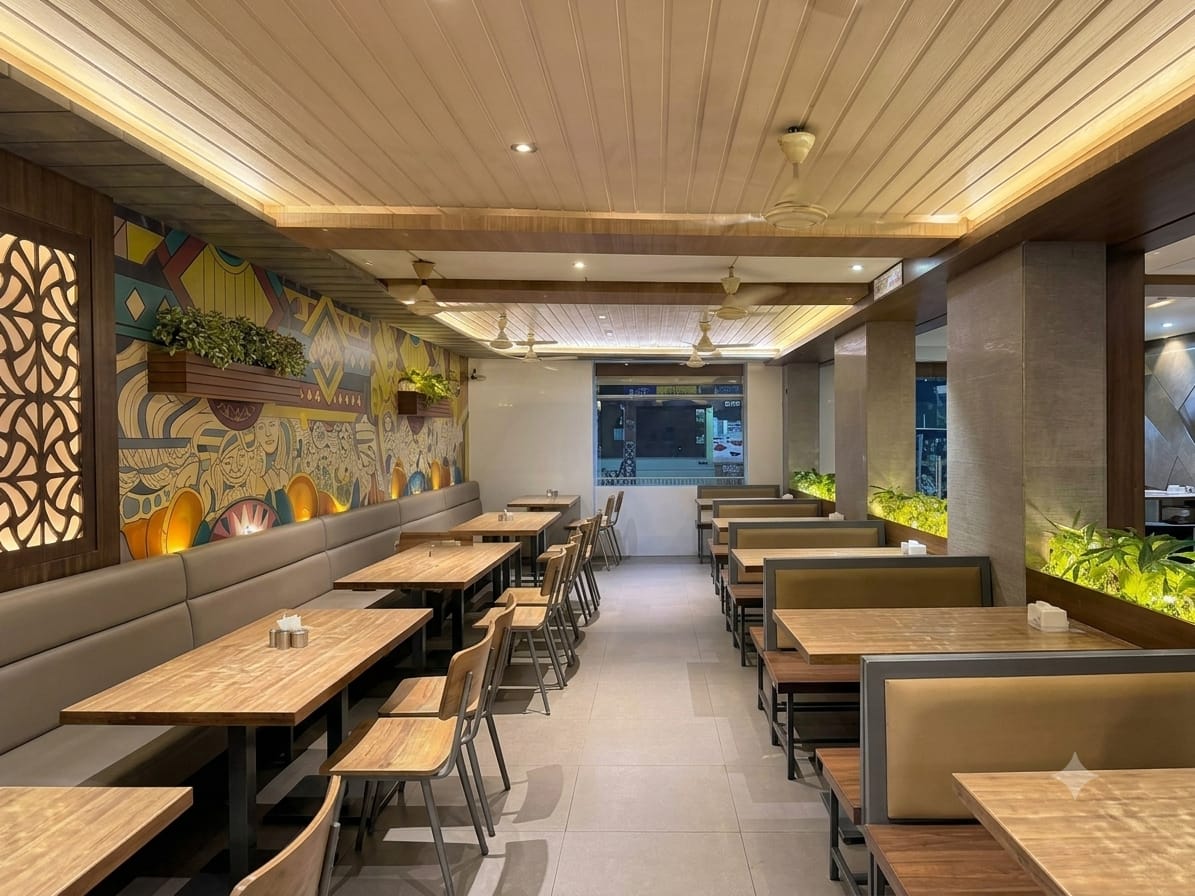 Hotel Sarika dining room with hand-painted mural and wooden tables