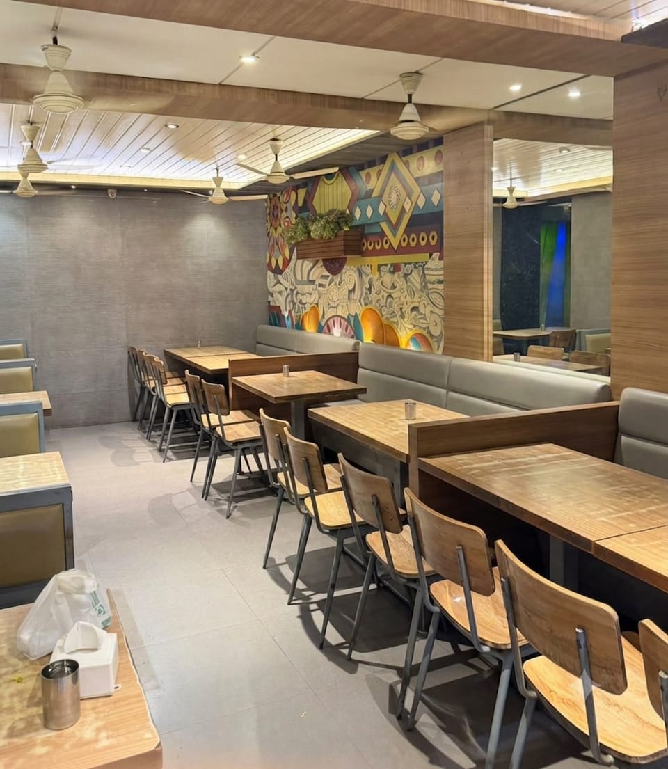 Hotel Sarika seating area with mural wall and family tables